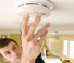 Man Checking Smoke Detector